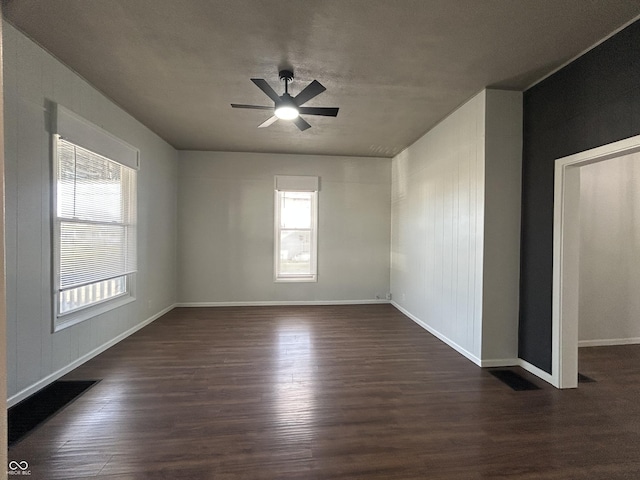 spare room with ceiling fan and dark hardwood / wood-style floors