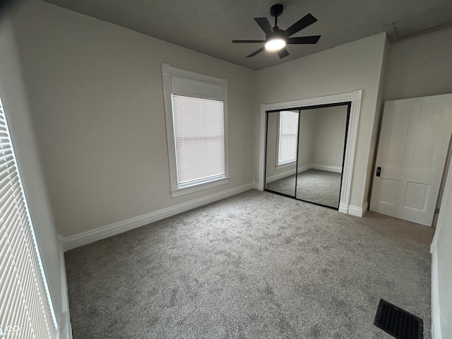 unfurnished bedroom with light colored carpet, ceiling fan, and a closet