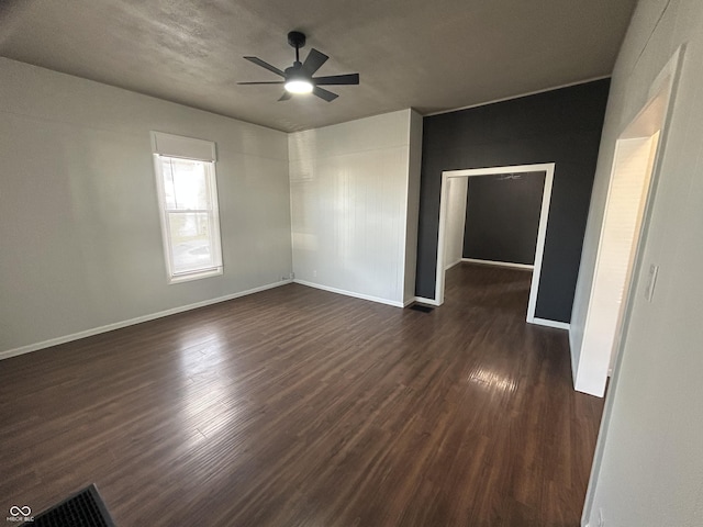 spare room featuring dark hardwood / wood-style floors and ceiling fan