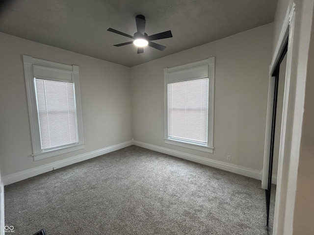 unfurnished bedroom featuring ceiling fan and carpet