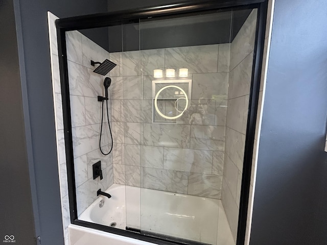 bathroom with bath / shower combo with glass door