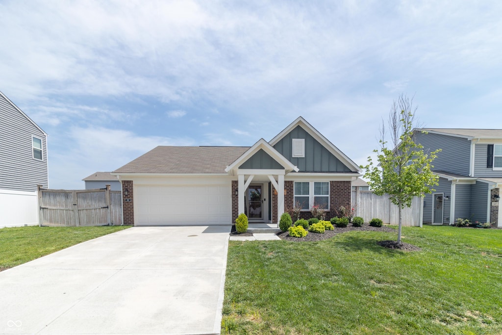 view of front of home featuring a garage and a front lawn