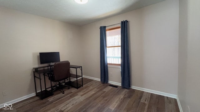 office with dark wood-type flooring