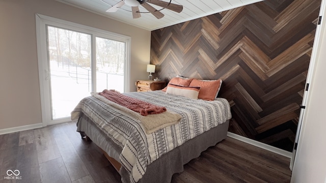 bedroom featuring dark hardwood / wood-style flooring, ornamental molding, and ceiling fan