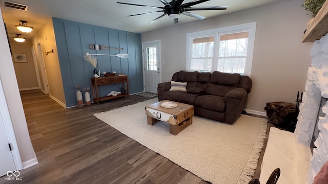 living room with ceiling fan and dark hardwood / wood-style flooring