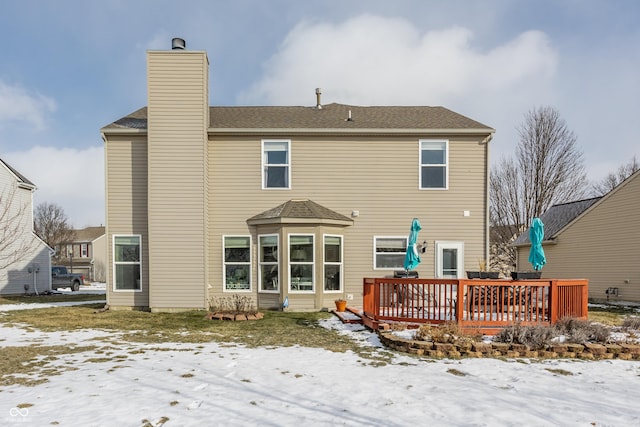 snow covered property featuring a deck