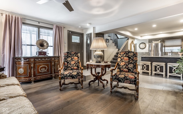 living area with ceiling fan and hardwood / wood-style flooring