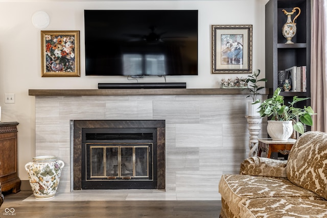 interior details featuring a tile fireplace