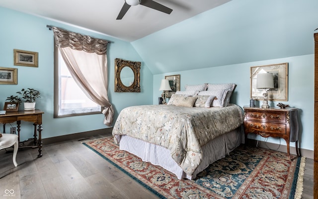 bedroom featuring baseboards, wood finished floors, a ceiling fan, and vaulted ceiling