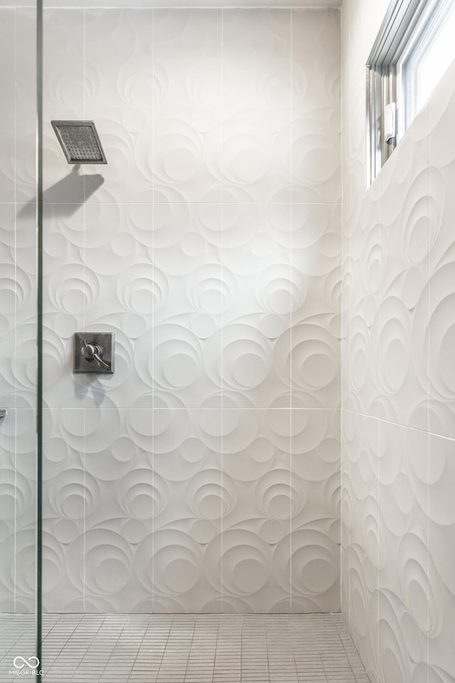 full bath featuring walk in shower and tile patterned flooring