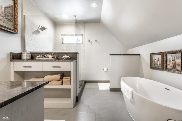 full bath featuring lofted ceiling, a walk in shower, baseboards, a freestanding bath, and vanity