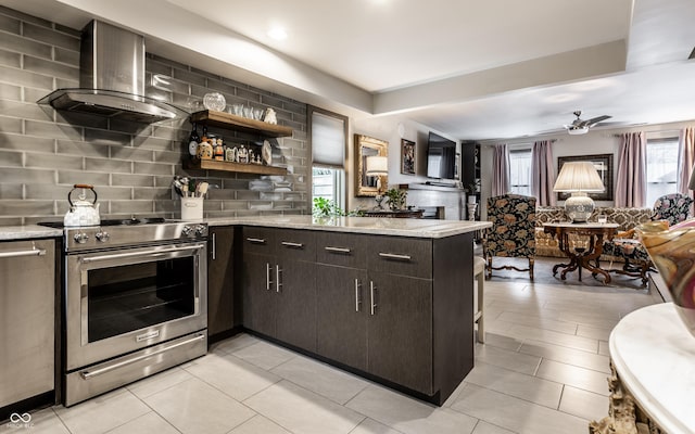 kitchen featuring wall chimney exhaust hood, tasteful backsplash, kitchen peninsula, stainless steel range with electric stovetop, and dark brown cabinets