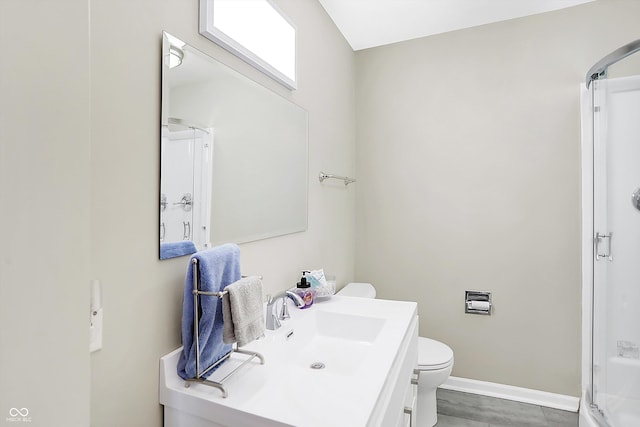 bathroom with toilet, vanity, and an enclosed shower