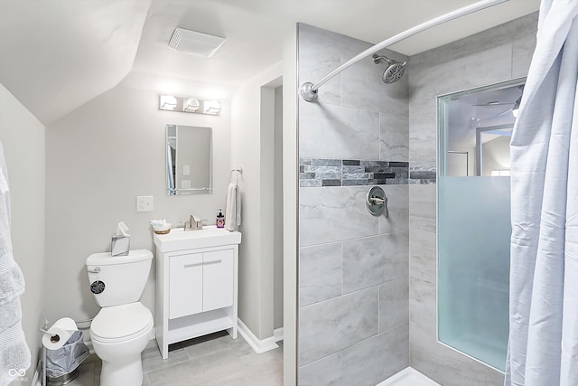 bathroom featuring lofted ceiling, vanity, toilet, and tiled shower