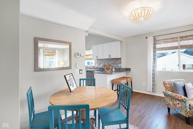 dining area featuring dark wood-type flooring and plenty of natural light