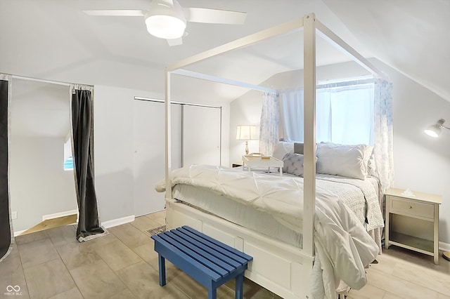 bedroom featuring ceiling fan, multiple windows, and vaulted ceiling