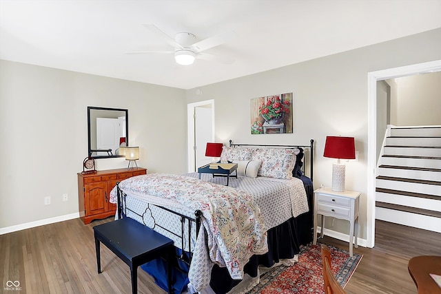 bedroom with ceiling fan and dark hardwood / wood-style flooring