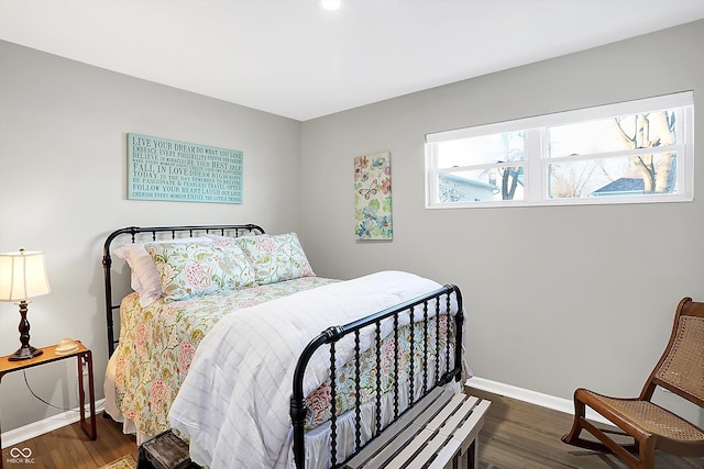 bedroom with dark hardwood / wood-style flooring