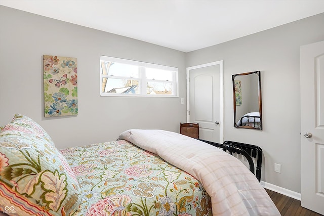 bedroom with dark hardwood / wood-style floors