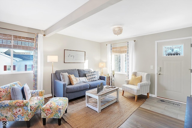 living room featuring beam ceiling and hardwood / wood-style flooring