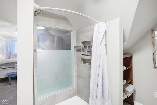 bathroom with lofted ceiling and a shower with curtain