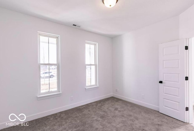 unfurnished room featuring light colored carpet