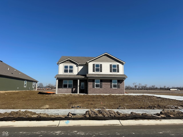 view of front of house featuring brick siding