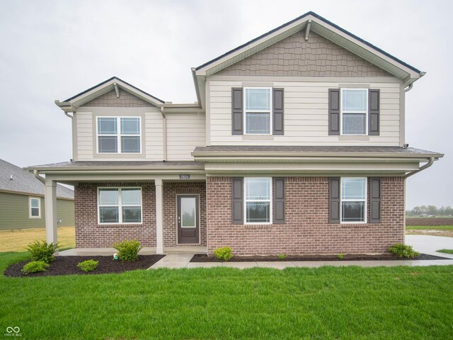 7824 Magnolia St, New Palestine, IN 46163 - view of front facade with brick siding, a front yard, and a shingled roof