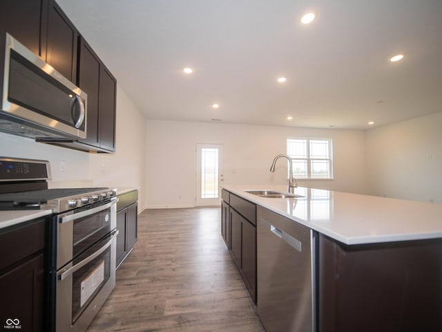 7824 Magnolia St, New Palestine, IN 46163 - kitchen with stainless steel appliances, wood finished floors, recessed lighting, light countertops, and a kitchen island with sink