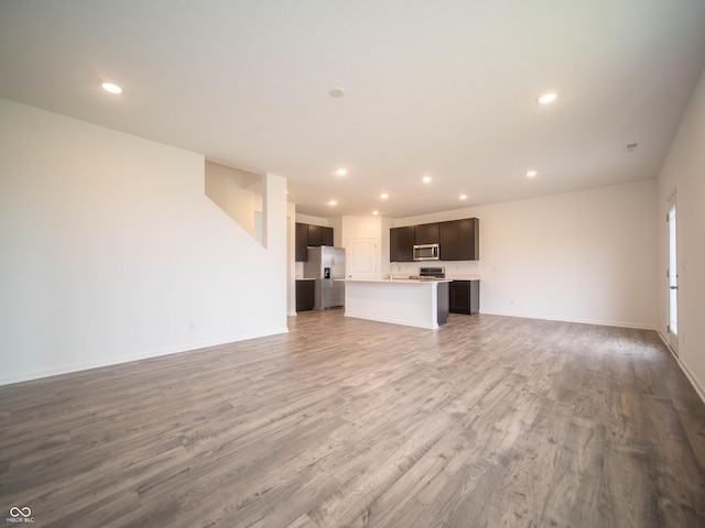 7824 Magnolia St, New Palestine, IN 46163 - unfurnished living room featuring recessed lighting and wood finished floors