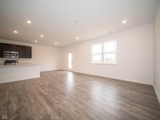 7824 Magnolia St, New Palestine, IN 46163 - unfurnished living room featuring recessed lighting and wood finished floors