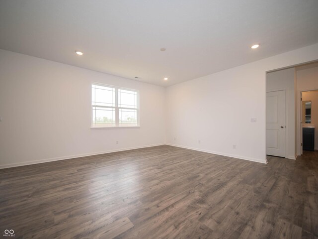 7824 Magnolia St, New Palestine, IN 46163 - empty room featuring dark wood-style flooring and recessed lighting