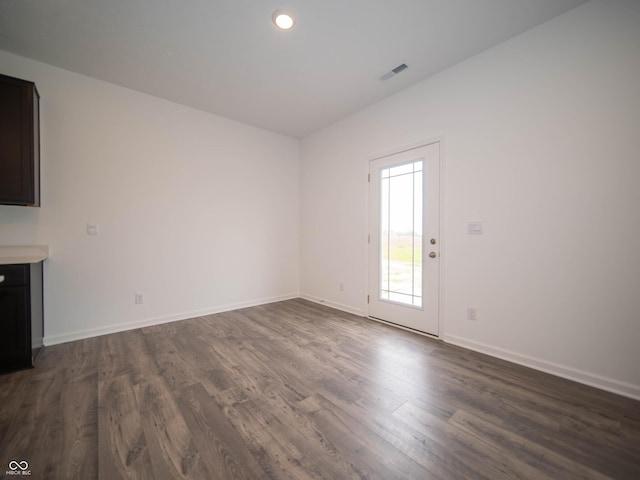 7824 Magnolia St, New Palestine, IN 46163 - unfurnished living room with dark wood-style flooring and recessed lighting