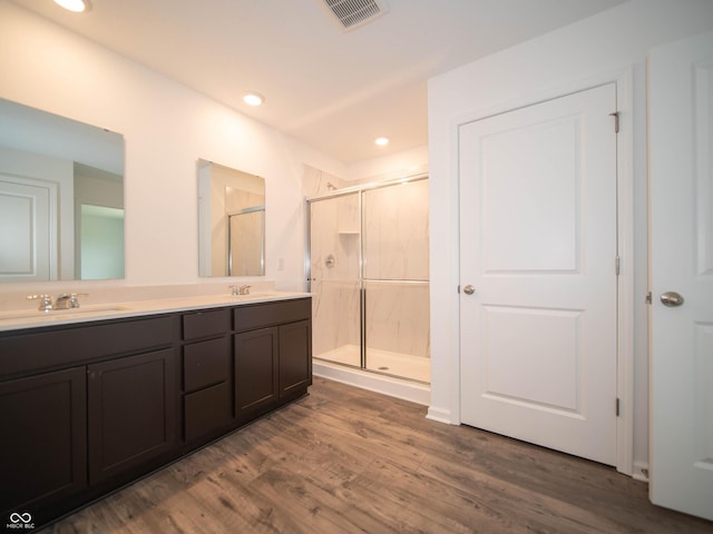 7824 Magnolia St, New Palestine, IN 46163 - bathroom featuring a shower stall, double vanity, wood finished floors, and recessed lighting