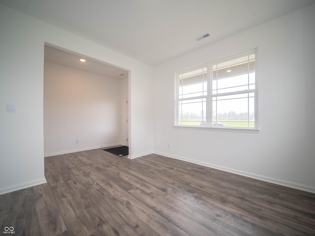 7824 Magnolia St, New Palestine, IN 46163 - empty room featuring dark wood-style flooring and recessed lighting