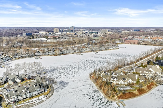 snowy aerial view featuring a water view