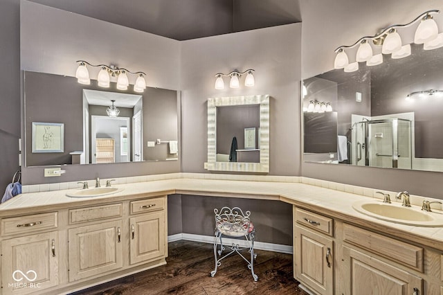 bathroom with wood-type flooring, an enclosed shower, and vanity