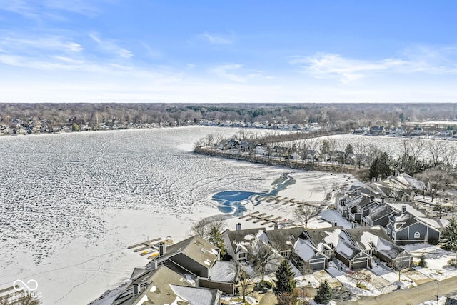 snowy aerial view featuring a water view