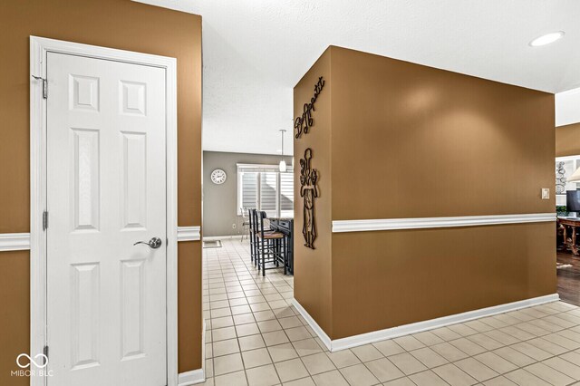 hall featuring light tile patterned floors