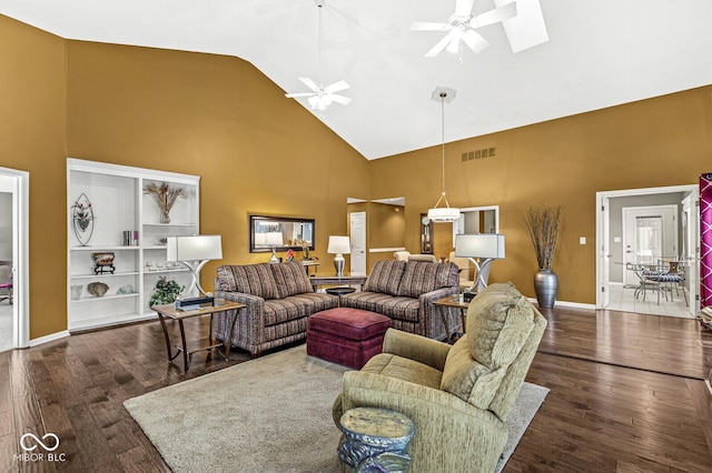 living room with a skylight, high vaulted ceiling, dark hardwood / wood-style floors, and ceiling fan