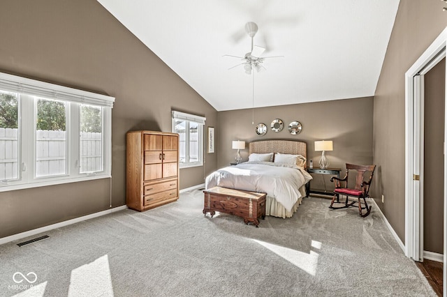 carpeted bedroom with multiple windows, high vaulted ceiling, and ceiling fan