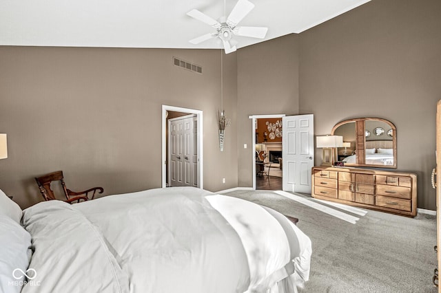 bedroom with ceiling fan, lofted ceiling, a closet, and carpet