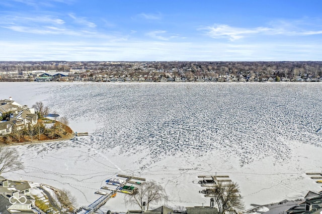 snowy aerial view featuring a water view