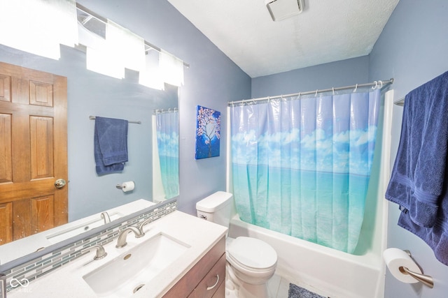 full bathroom featuring toilet, vanity, shower / tub combo, and a textured ceiling