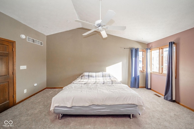 bedroom featuring ceiling fan, light carpet, and vaulted ceiling