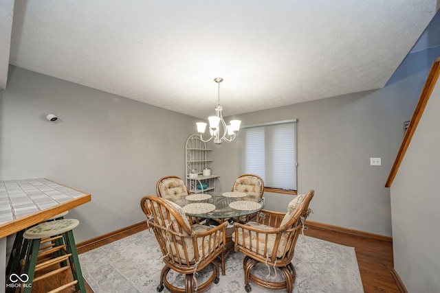 dining room featuring hardwood / wood-style floors and a chandelier