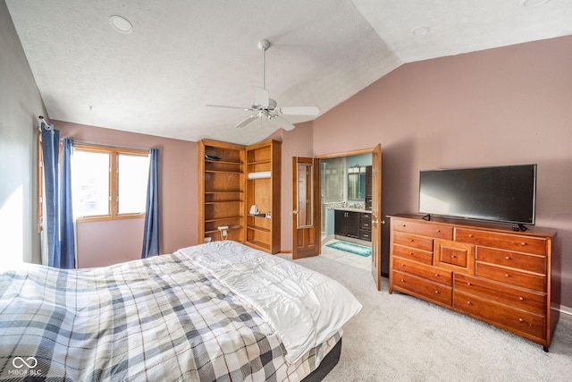 bedroom with lofted ceiling, ceiling fan, light carpet, and ensuite bathroom