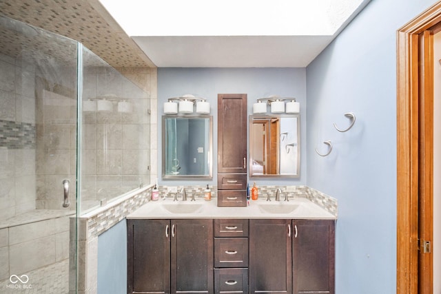 bathroom with walk in shower, vanity, and a skylight