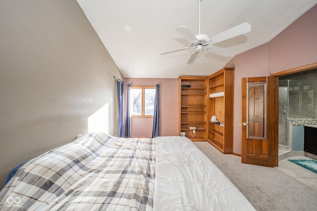 carpeted bedroom with ceiling fan, ensuite bath, and vaulted ceiling