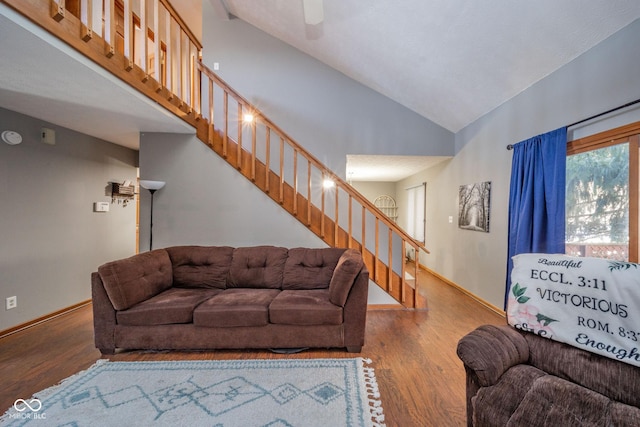 living room with high vaulted ceiling and wood-type flooring